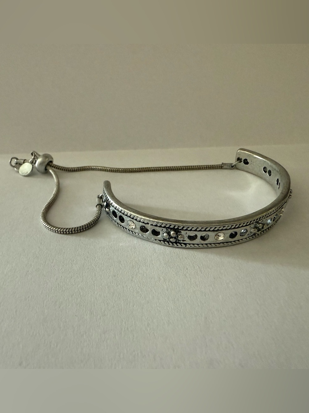 Adjustable bracelet. Silver color with clear jewel accents